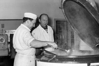 Two cooks preparing lunch for employees